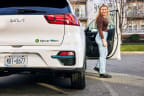 a woman getting out of a car with the door open