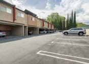 Thumbnail 36 of 41 - Studio Apartments In West Hills, CA - Topanga Canyon - Parking Lot With Assigned Parking Spaces Behind Apartments