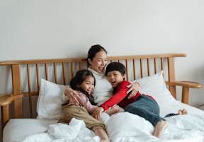 Mother and Children Lying on the Bed at Madison Shelby Farms in East Memphis, TN