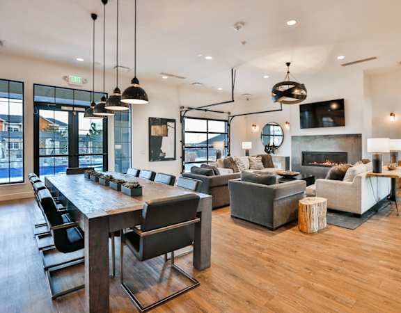A modern living room with a wooden floor and a fireplace. at The Vineyards of Colorado Springs, Colorado Springs