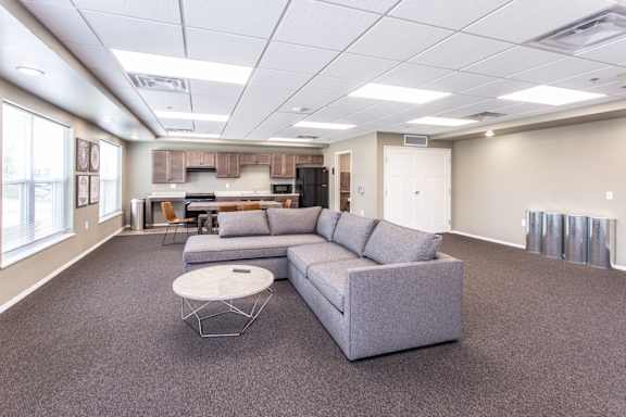 A spacious living room with a grey sofa and a coffee table.