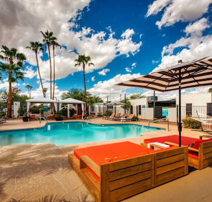 A pool area with a sun lounger and a pool.