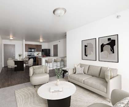 A living room with a couch, chairs, and a coffee table.