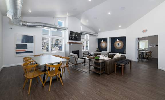 A modern living room with a dining table and chairs.