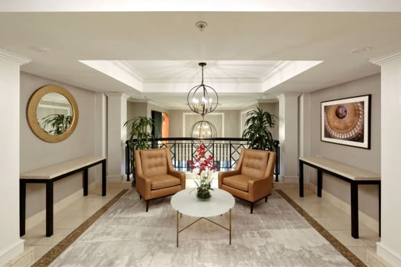 a lobby with two chairs and a table