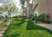 Thumbnail 37 of 41 - Apartments in West Hills for Rent - Topanga - Grassy Courtyard with Palm Trees