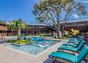 Thumbnail 5 of 30 - Resort-style pool surrounded by lounge seating at Reserve on Abrams Dallas