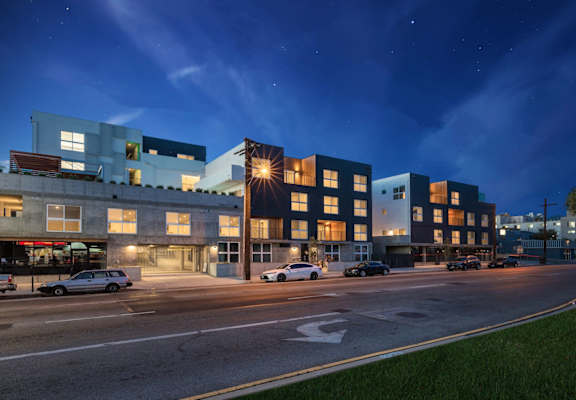 a view of a city street at night with buildingsat the perch, Los Angeles California