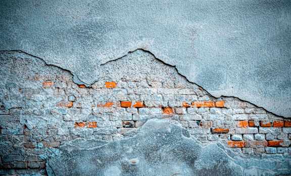 A wall with a large crack and exposed bricks. at Countryside River Apartments, Wilmington, 60402