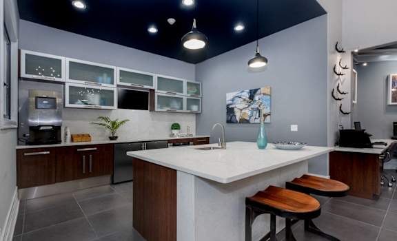a kitchen with a large island with two stools