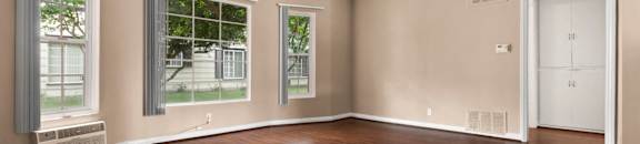 Apartments for Rent in Van Nuys - Colonial Manor Expansive Living Room with Hardwood-Style Flooring and Multiple Large Windows