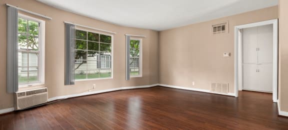 Apartments for Rent in Van Nuys - Colonial Manor Expansive Living Room with Hardwood-Style Flooring and Multiple Large Windows