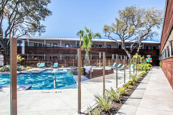 Resort-style pool surrounded by lounge seating at Reserve on Abrams Dallas