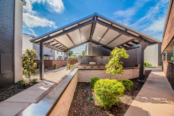 Covered outdoor lounge with grills and bar seating