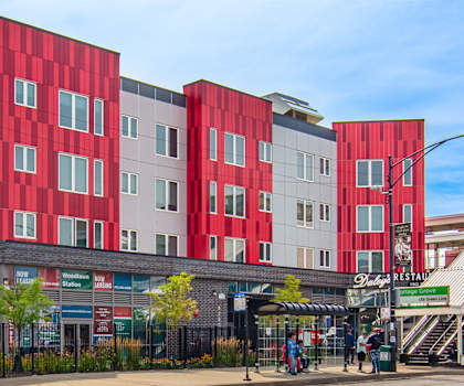 A red and white building with a staircase leading up to it.