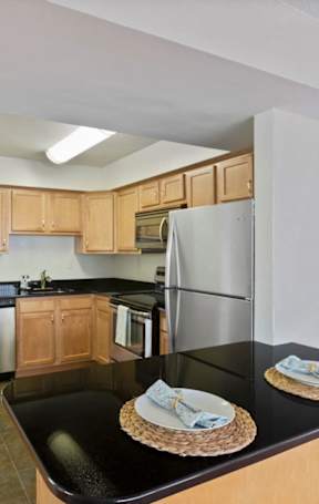 kitchen with stainless steel appliances and bar area at 1633 Q, Washington, 20009