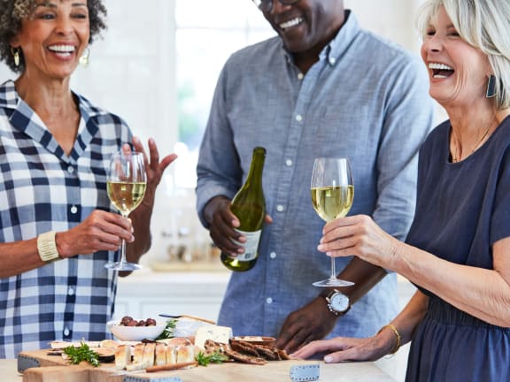 a group of people sitting at a table eating food at Nook at Northaven Apartments, Washington, 98125