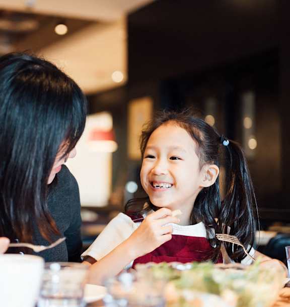 a woman sitting on a couch with two children at Nook at Northaven Apartments, Washington, 98125