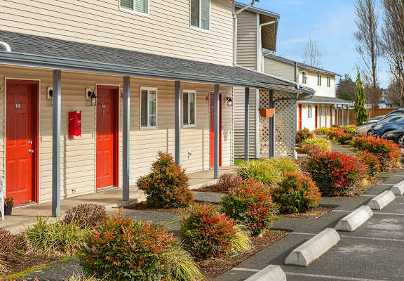 a row of apartment homes with red doors
