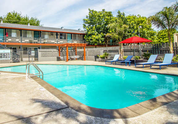 blue swimming pool with lounge seatig