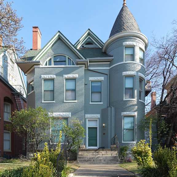 a house with a turret on the side of a street