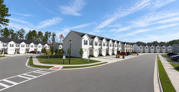 A street view of a residential area with houses on both sides.
