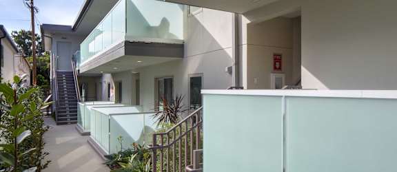 a view of the side of a building with glass walls