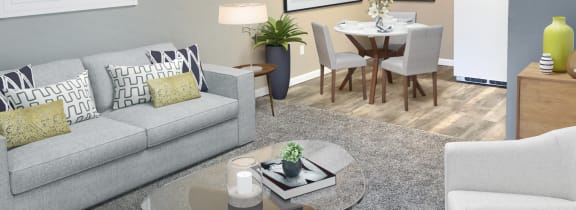Woodland Crossing Apartments living room staged with couch, chair, table and dining set.