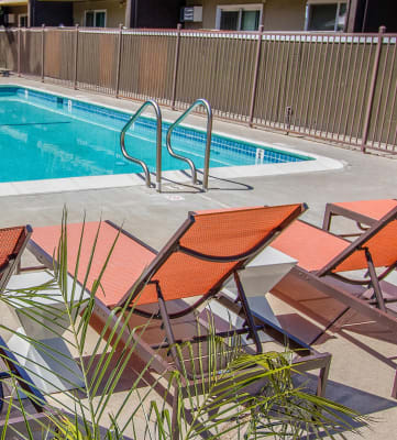 a pool with deck chairs it at Ella 1711, Woodland, CA 95695