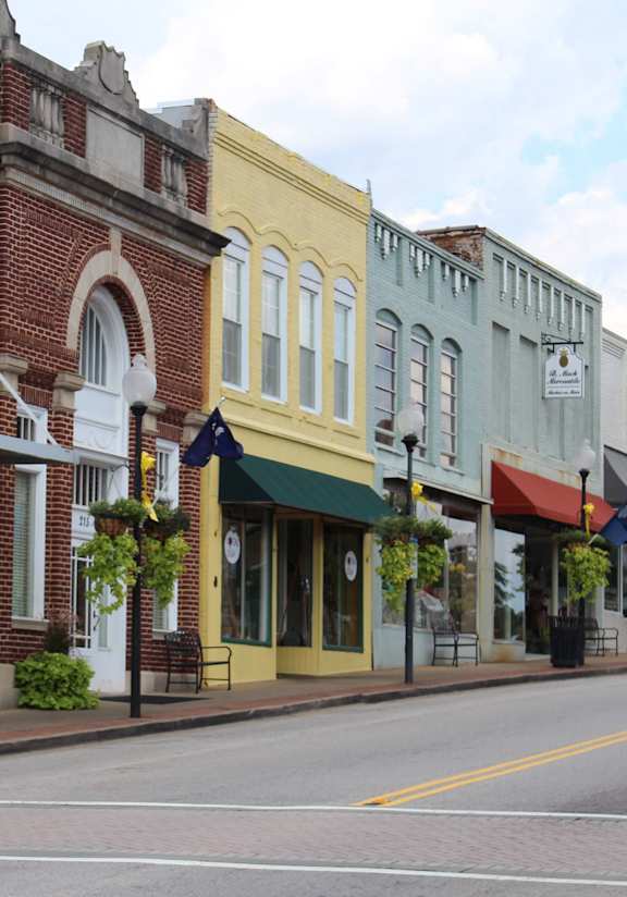 A row of colorful buildings line a street.