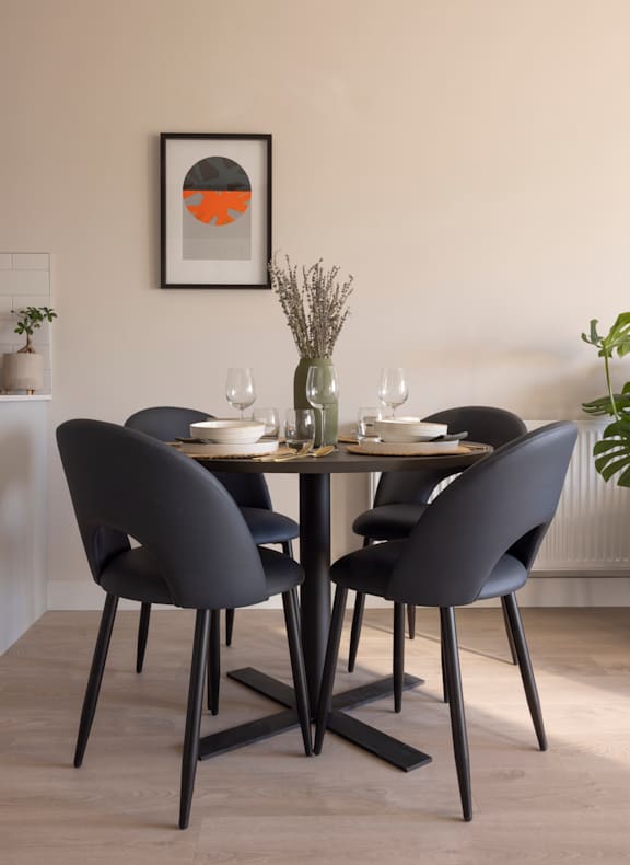 a dining room with a wooden table and grey chairs
