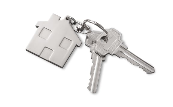 a pair of keys with a house keychain