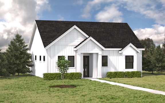 A white barn-style house with a black roof and a small tree in front.at Alante Homes at Spring Run, Caldwell, 83607