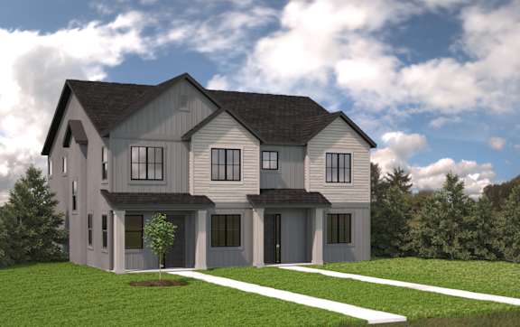 A modern house with a grey and white exterior and a black roof.