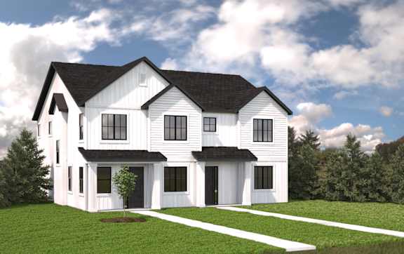A white house with a black roof and a tree in front of it.