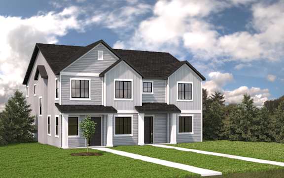 A modern house with a grey exterior and a black roof.