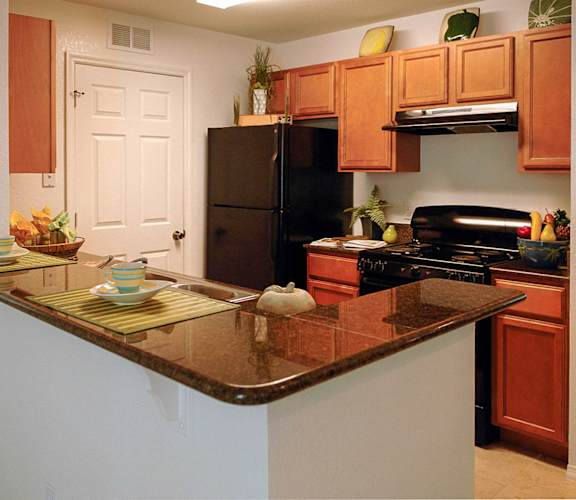 a kitchen with an island and black appliances