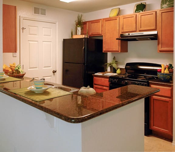 a kitchen with an island and black appliances