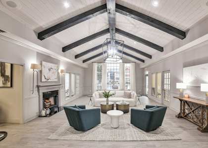 A large, open living room with a fireplace and a large window.