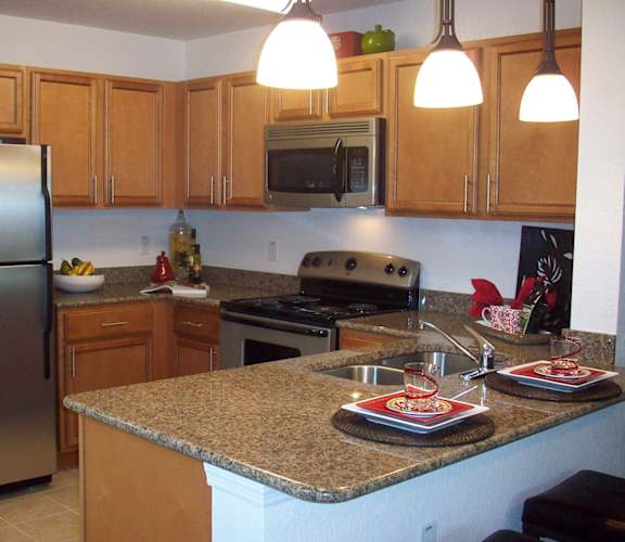 a kitchen with a granite counter top and stainless steel appliances