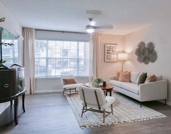 a living room with a couch and a chair and a table