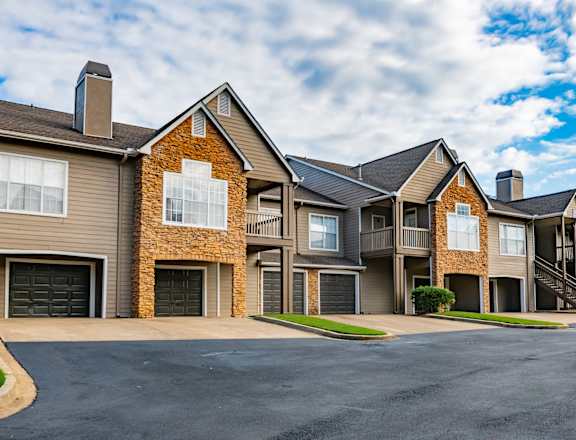 A large, modern apartment complex with multiple buildings and garages.