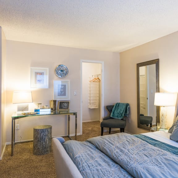 an open concept living room and dining area with a white dining table and rattan chairs