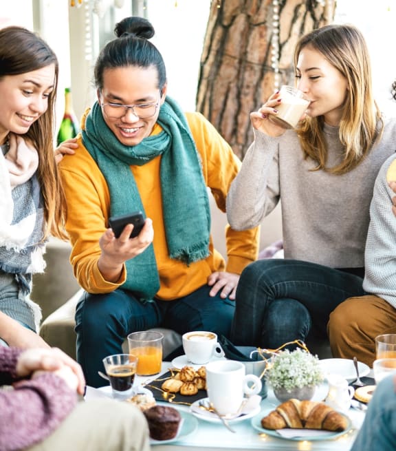 Friends Having Pastries and Coffee Together Smiling