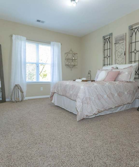 A bedroom with a large bed and a dresser.