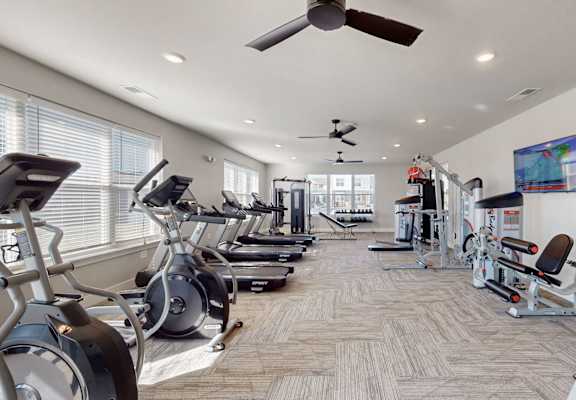 a gym with cardio machines and a ceiling fanat The Slate, Jeffersonville, 47130