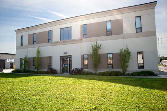 A modern building with a green lawn in front.