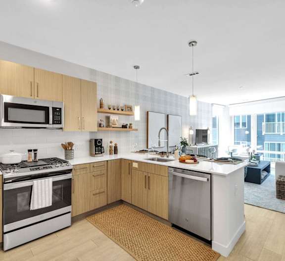 A modern kitchen with wooden cabinets and stainless steel appliances.