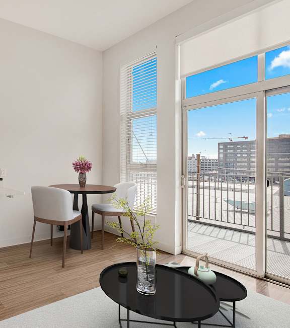 A kitchen with a refrigerator, sink, and coffee maker. at RiDE at RiNo Apartments, Colorado
