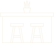 A black and white image of a bar with two stools and a potted plant on top.